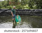 Latin american fisherman working in an eco-friendly tilapia fish farm, promoting sustainable aquaculture and local food production