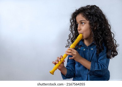 Latin American girl playing with skill the soprano recorder
