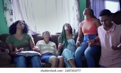 A Latin American Hispanic Family Praying At Home Joining Hands Together In Prayer. A Spiritual Group Of South American People Having HOPE And FAITH