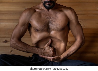 Latin American Male Yogi Sitting Practicing Nauli Kriya With Limgan Mudra. Concept Of Yoga And Meditation