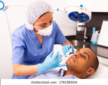 Latin American Man Getting Injections For Face Skin Tightening At Aesthetic Cosmetology Clinic 