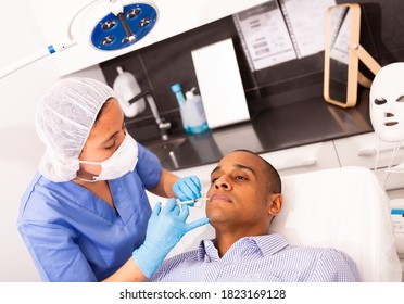 Latin American Man Getting Injections For Face Skin Tightening At Aesthetic Cosmetology Clinic