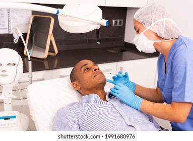 Latin American Man Getting Injections For Face Skin Tightening At Aesthetic Cosmetology Clinic