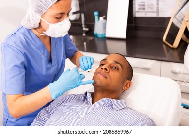 Latin American Man Getting Injections For Face Skin Tightening At Aesthetic Cosmetology Clinic