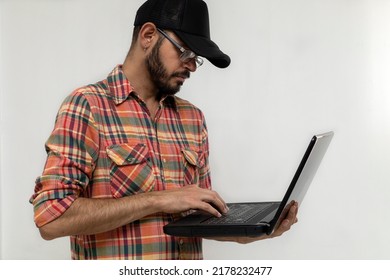 Latin American Man With His Laptop Computer Is A Programmer And Specializes In Web Development.