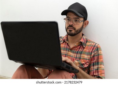 Latin American Man With His Laptop Computer Is A Programmer And Specializes In Web Development.