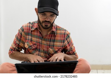 Latin American Man With His Laptop Computer Is A Programmer And Specializes In Web Development.