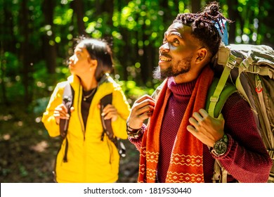 latin american man and hispanic woman in a forest having a rest - Powered by Shutterstock