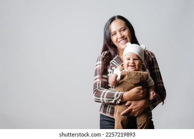  Latin American mom with her baby. Mother's Love. Baby smiling. Single mother and her son. Mother and baby very happy. Young mother holding her baby. - Shutterstock ID 2257219893