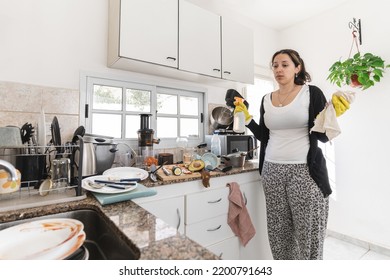 Latin American Woman Getting Ready For Cleaning Messy Kitchen