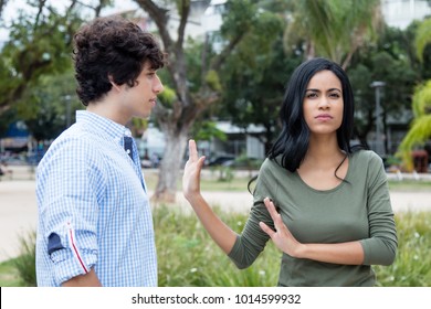 Latin american woman rejecting man outdoors in the city