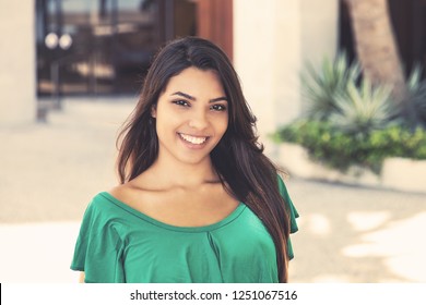 Latin American Young Adult Woman In Green Shirt In Summer In City