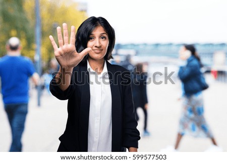 latin business woman doing number five gesture