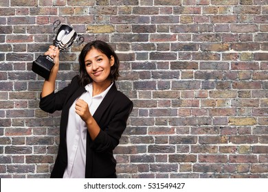 Latin Business Woman Holding A Trophy