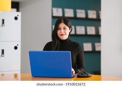 Latin Business Woman Working With Computer At The Office In Mexico City