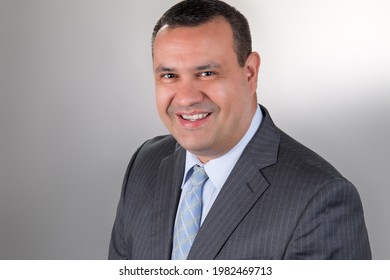 Latin Businessman. Middle-aged Man Wearing Suit. Studio Photography With A Clear And Clean Background. Smiling Man. Space For Text.