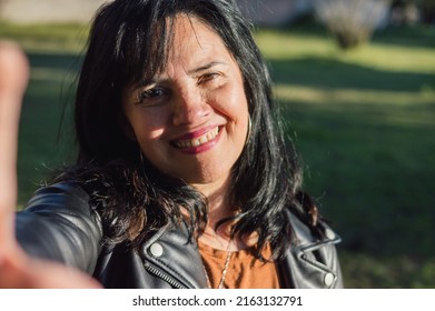 Latin Caucasian Adult Woman, Outside In Farm Backyard Smiling Taking A Selfie, Phone Camera Perspective. Technology And Communication Concept.