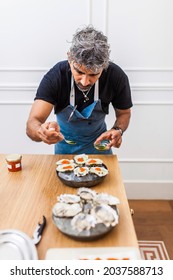 Latin Cook Cooking Oysters During Private Dinner At Home