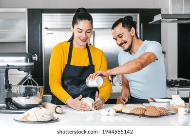 Latin Couple Bakers Preparing Dough For Baking Mexican Bread Called Conchas In Kitchen In Mexico City