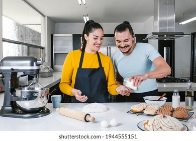 Latin Couple Bakers Preparing Dough For Baking Mexican Bread Called Conchas In Kitchen In Mexico City