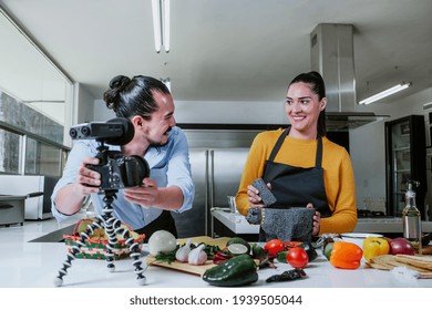 latin couple blogger vlogger and online influencer recording video content on mexican food in the kitchen in Mexico city