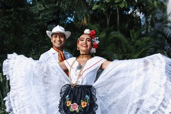 Latin Couple Of Dancers Wearing Traditional Mexican Dress From Veracruz Mexico Latin America, Young Hispanic Woman And Man In Independence Day Or Cinco De Mayo Parade Or Cultural Festival