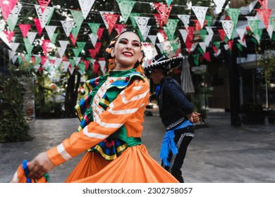 Latin couple of dancers wearing traditional Mexican dress from Guadalajara Jalisco Mexico Latin America, young hispanic woman and man in independence day or cinco de mayo parade or cultural Festival - Shutterstock ID 2302758057