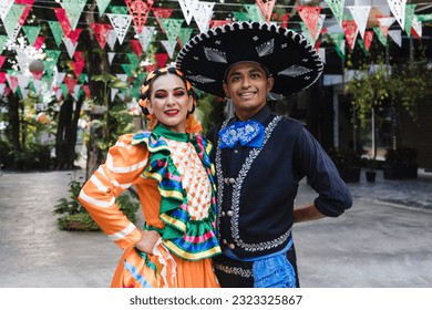 Latin couple of dancers wearing traditional Mexican dress from Guadalajara Jalisco Mexico Latin America, young hispanic woman and man in independence day or cinco de mayo parade or cultural Festival - Shutterstock ID 2323325867