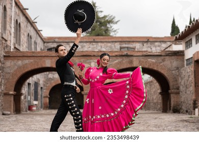 Latin couple of dancers wearing traditional Mexican dress from Guadalajara Jalisco Mexico Latin America, young hispanic woman and man in independence day or cinco de mayo parade or cultural Festival - Shutterstock ID 2353498439