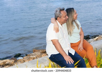 Latin Couple Is Sitting In The Park Talking About