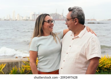 Latin Couple In Their 50s Standing In A Park