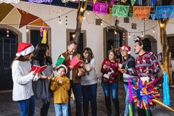 Latin Family Celebrating Mexican Posadas And Singing Carols In Christmas Eve In Mexico Latin America, Hispanic Culture And Traditions