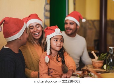 Latin family having fun together during christmas dinner at home - Powered by Shutterstock