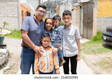 Latin Family Hugging Outside Their House In Rural Area - Happy Hispanic Family In The Village