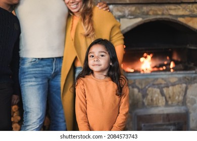 Latin Family Love - Cute Little Girl Looking On Camera With Fireplace In Background