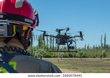 latin firefighter piloting rescue drone