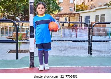 latin girl goalkeeper football player on a soccer goal with football ball - Powered by Shutterstock