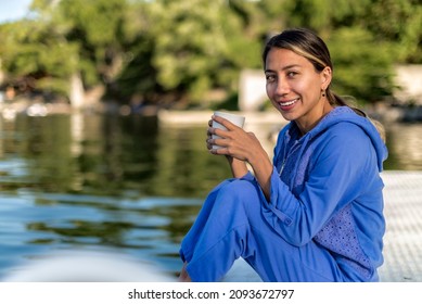 Latin Girl With Having Coffee By A Lake In A Summer Morning Smiling