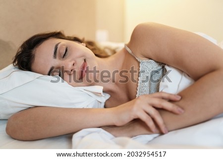 Latin girl sleeping in a very comfortable bed