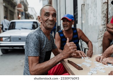 Latin group of elderly men playing dominoes in Old Havana Cuba, Caribbean black people - Powered by Shutterstock