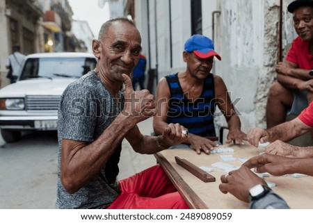 Latin group of elderly men playing dominoes in Old Havana Cuba, Caribbean black people
