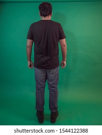 Latin Guy On Green Background In A Full Body Facing Backwards