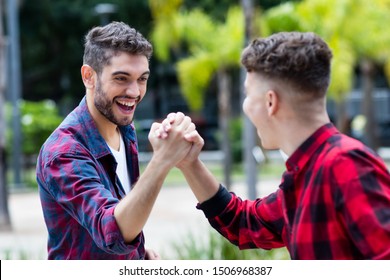 Latin hipster young adult giving high five to friend outdoor in summer in city - Shutterstock ID 1506968387