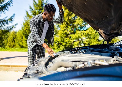 latin hispanic stressed man having trouble with his broken car outdoors