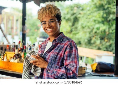 latin hispanic woman barmaid working at tropical hotel or restaurant