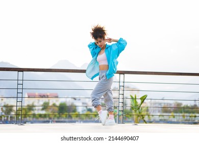 Latin Hispanic Woman Dancing Outdoors At Sunset In Street