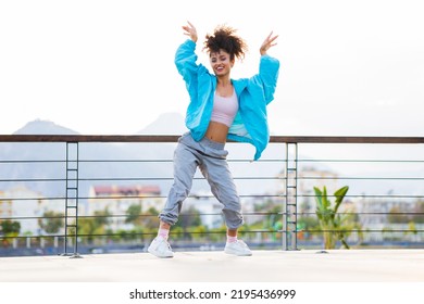 Latin Hispanic Woman Dancing Outdoors At Sunset In Street