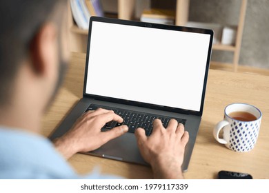 Latin Indian Adult Student Typing Working Remotely Online On Training Educational Webinar Chatting At Home Office Using Laptop Computer Looking At Mockup Empty Screen. Over Shoulder View.