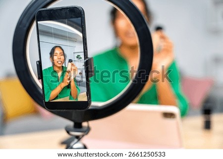 Latin influencer recording a makeup tutorial video, showing beauty products and giving recommendations to her followers