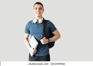 Latin Male College Student With A Backpack And Headphones Ready For School